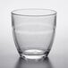 A Duralex clear glass tumbler on a white surface.