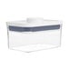 A clear plastic OXO Good Grips food storage container with a white lid.