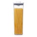 An OXO Good Grips square food storage container with spaghetti inside and a white lid.