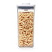 A close-up of a OXO Good Grips clear square plastic food storage container with pasta inside.