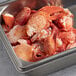 A large metal container filled with Boston Lobster Company claw and knuckle lobster meat.