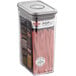 An OXO rectangular clear plastic food storage container with a stainless steel lid on a counter filled with pasta.