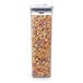 A clear OXO food storage container filled with cereal.
