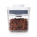 An OXO food storage container with star anise in it.