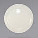 An International Tableware Valencia stoneware plate with a narrow rim on a white surface.