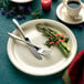 An International Tableware Valencia stoneware plate with asparagus and a cup of coffee.