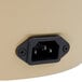 A close-up of a Town electric rice cooker plug in a power outlet.