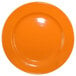 An orange International Tableware stoneware plate with a rolled edge and wide rim.