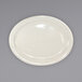 An International Tableware Valencia ivory stoneware platter with a narrow rim on a gray surface.