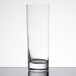 An Arcoroc highball glass on a white surface.