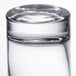 An Arcoroc highball glass on a table in a bar.