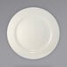 An International Tableware stoneware plate with a white circular edge on a gray background.