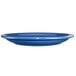 A light blue International Tableware stoneware plate with a rolled rim.