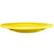 A yellow International Tableware Cancun stoneware plate with a wide rim.