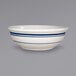 A close up of a white International Tableware stoneware bowl with blue lines.