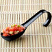 A black Fineline Tiny Temptations plastic spoon with chopped vegetables on it.