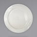 A white plate with a curved edge on a gray background.