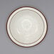a white plate with brown speckled rim