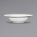 An ivory stoneware bowl with an embossed rim.