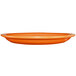 An orange International Tableware narrow rim platter on a white background.