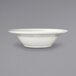An International Tableware Athena stoneware bowl with a wide rim on a gray background.