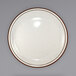 An International Tableware ivory stoneware plate with a brown speckled narrow rim.