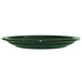A close up of a International Tableware green stoneware plate with a narrow rim.