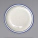 An ivory stoneware plate with a blue speckled and blue banded rim.