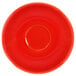 A crimson red International Tableware saucer with a circle in the middle.