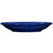 A cobalt blue stoneware saucer with a white background.