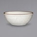 An ivory bowl with brown speckled rim.