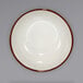 A white bowl with a narrow brown speckled rim.