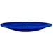 A cobalt blue stoneware plate with a wide rim.
