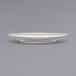 A close up of an International Tableware Roma ivory cappuccino saucer with a wide rim.