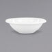 A white bowl with a black rim on a white surface.