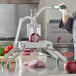 A woman using a Garde onion slicer to cut onions on a counter.