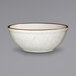 a white bowl with brown specks