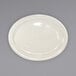 An International Tableware ivory stoneware platter with a narrow rim on a gray surface.