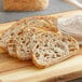 Slices of bread on a cutting board next to a bowl of flour.