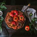 A FINEX cast iron skillet filled with a tomato dish on a table.