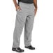 A person wearing Uncommon Chef houndstooth chef pants in black and white.