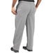 Uncommon Chef women's customizable houndstooth chef pants with pockets and a zipper being worn by a person with their hands in the pockets.