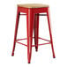 A red Lancaster Table & Seating backless counter height stool with a natural wood seat.