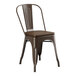A brown metal Lancaster Table & Seating restaurant chair with a wooden seat.