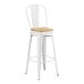 A white Lancaster Table & Seating barstool with a natural wood seat.