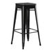 A Lancaster Table & Seating black metal bar stool with a black wood seat.