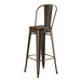 A brown metal Lancaster Table & Seating bar stool with a backrest.