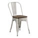 A Lancaster Table & Seating metal chair with a wooden seat.