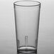 A Carlisle clear plastic tumbler on a table.