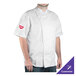 A man wearing a white Chef Revival short sleeve chef jacket.